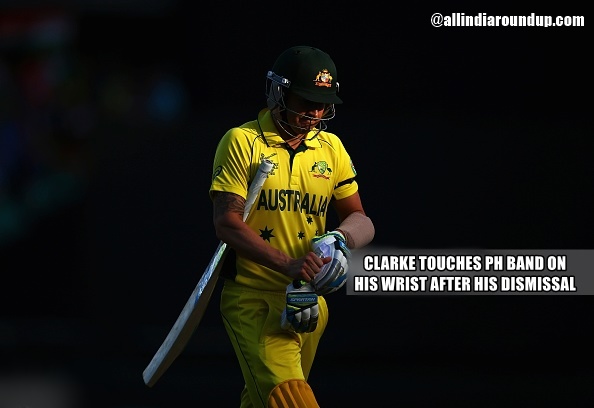 Michael Clarke touches the PH band on his wrist