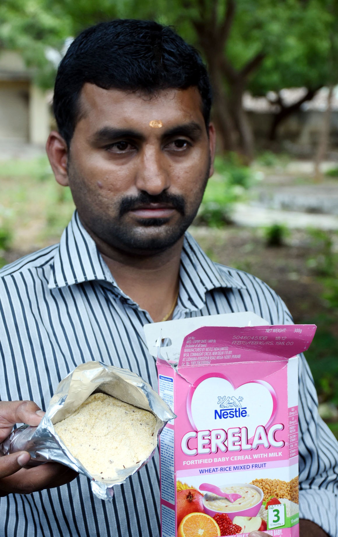 S Sriram, with a packet of baby cereal, in which were found live Weevils at the office of the Deputy Director of Public Health Services on Tuesday