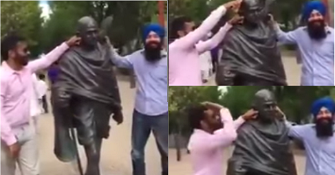 Two Indians Hitting Mahatma Gandhi Statue With Shoes In Canada