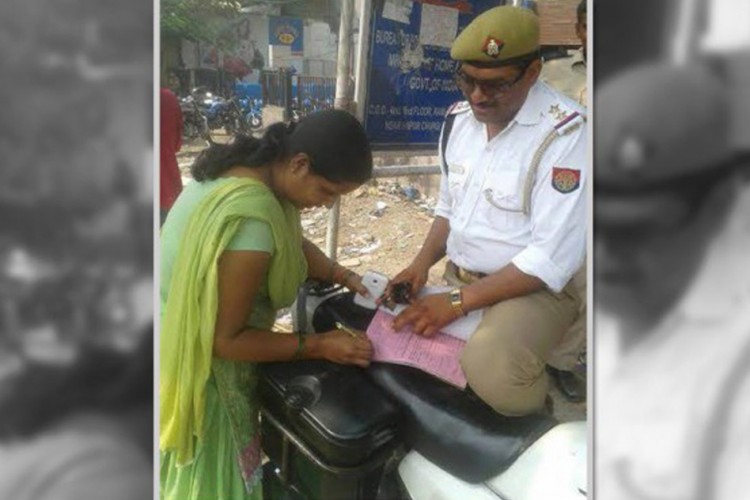 cop issuing penalty for his wife not wearing helmet whil driving her scooty in ghaziabad