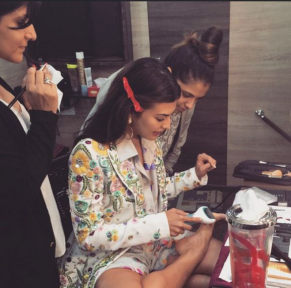 Jacqueline shared a picture of her showing her newest gadget to the girls in her make-up room.