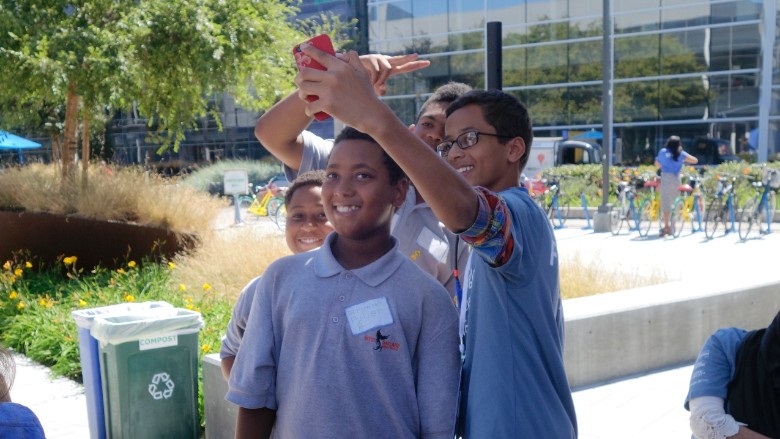 Ahmed Mohamed taking pictures with students.