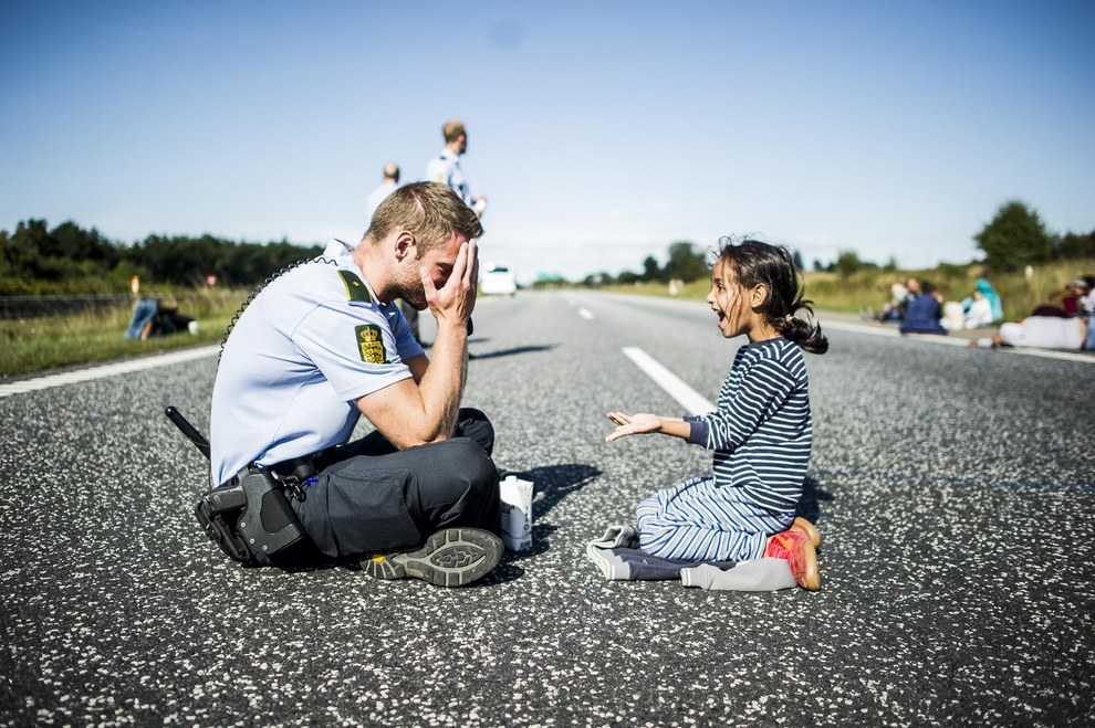 syrian refugee girl with danish police cop