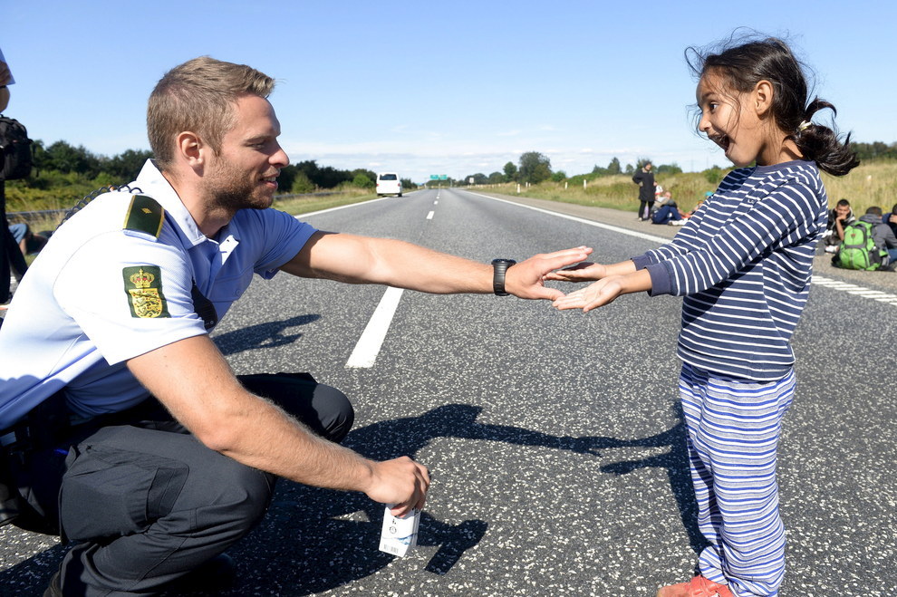 danish cop and refugee girl sharing playful moments 
