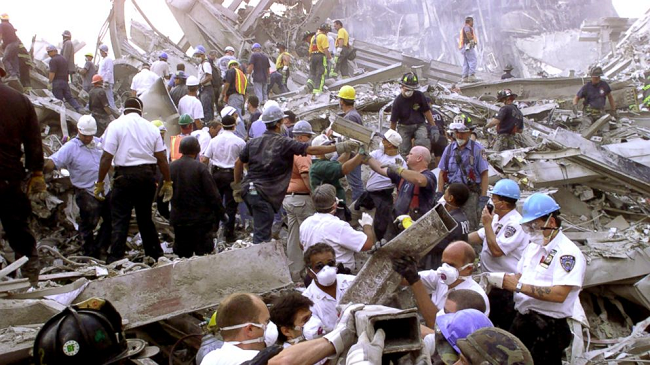 Rescue workers remove rubble at the World Trade Center after it was struck by a commercial airliner in a terrorist attack