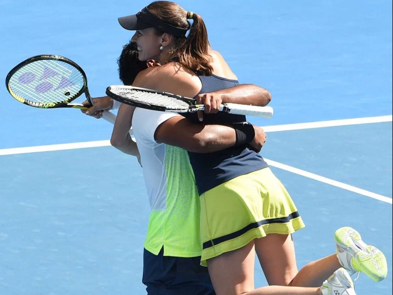 Paes and Hingis celebrating their third title in the year