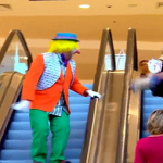 Clown Throwing Pie On Escalator