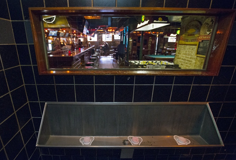 A one-way mirror is seen above the urinal at Streeter's Tavern in Chicago, Illinois, United States