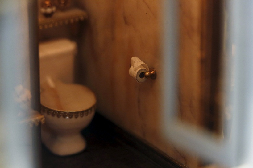 miniature roll of toilet paper is shown in the "bathroom" of the Astolat Castle