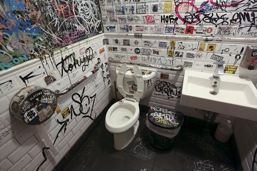 Graffiti is painted on the bathroom walls at a restaurant in the Williamsburg area of Brooklyn borough in New York
