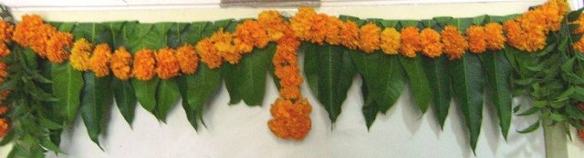 Ugadi image with green mango leaves and flowers