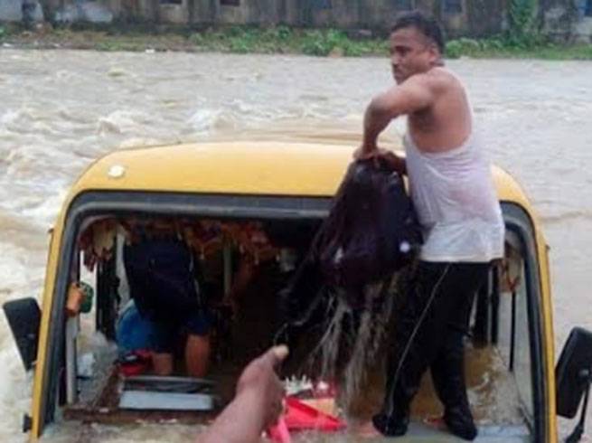 Villagers rescuing children from bus