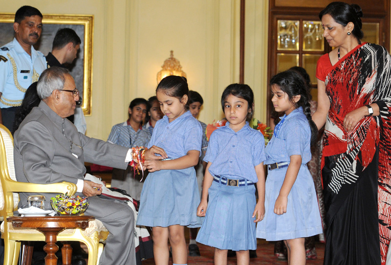 The school children tying Rakhi to the President of India on the occasion of Raksha Bandhan