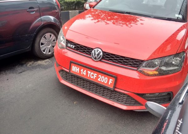 Red number plate with white text