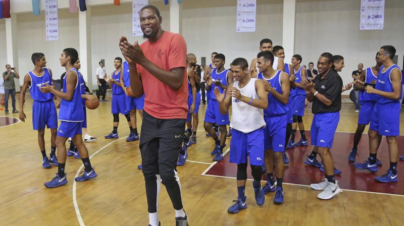 Kevin Durant with junior basketball players