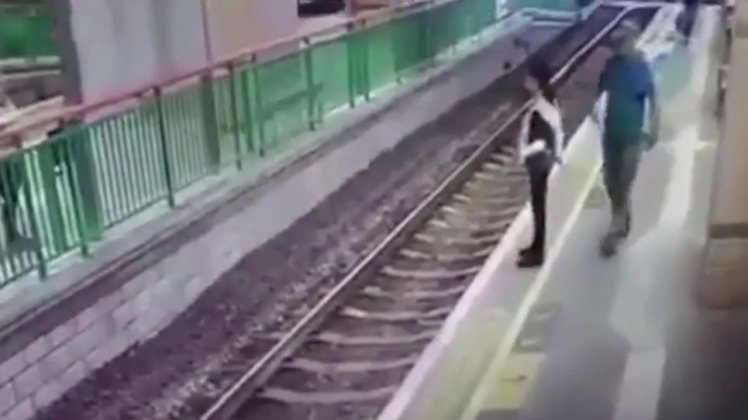 Man shoves unsuspecting woman onto train tracks