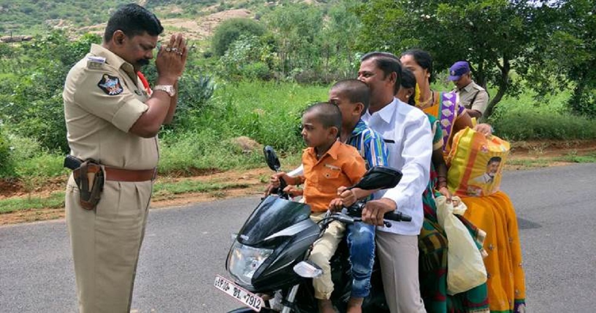 ap-police-holding-hands after seeing a man driving his bike with four others on it
