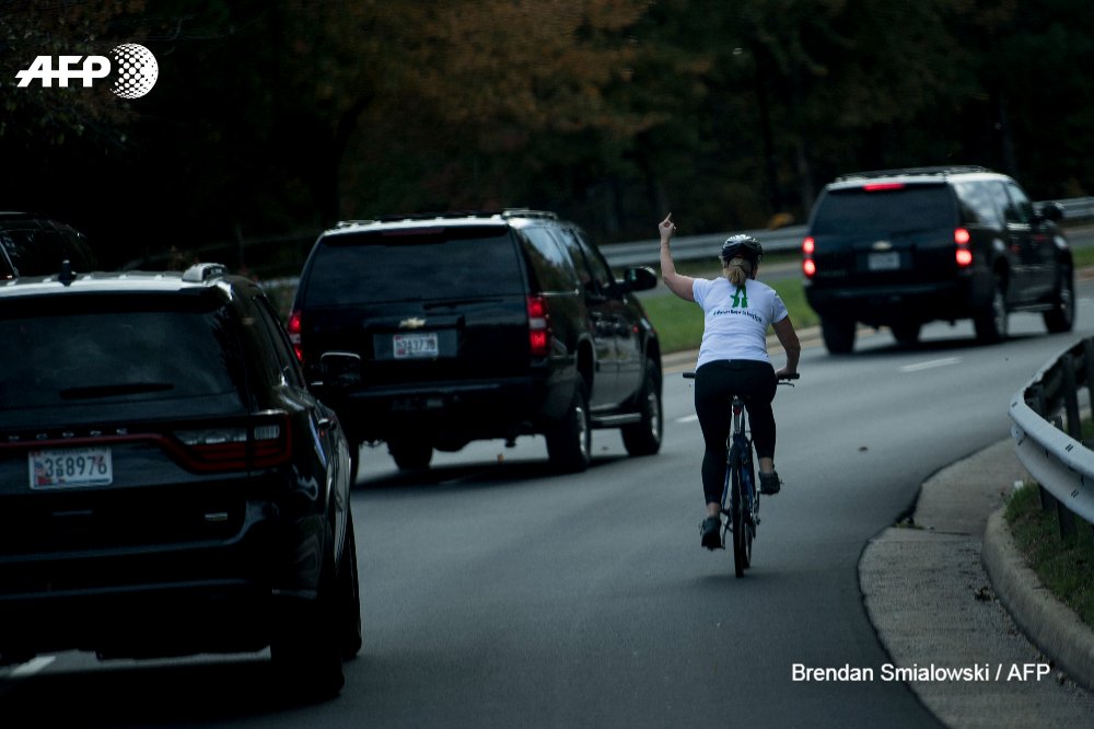 Woman cyclist gestures at US Prez Donald Trump as motorcade passes; photo goes viral