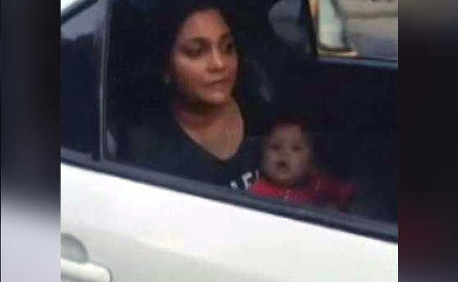 woman breast feeding her child in car mumbai
