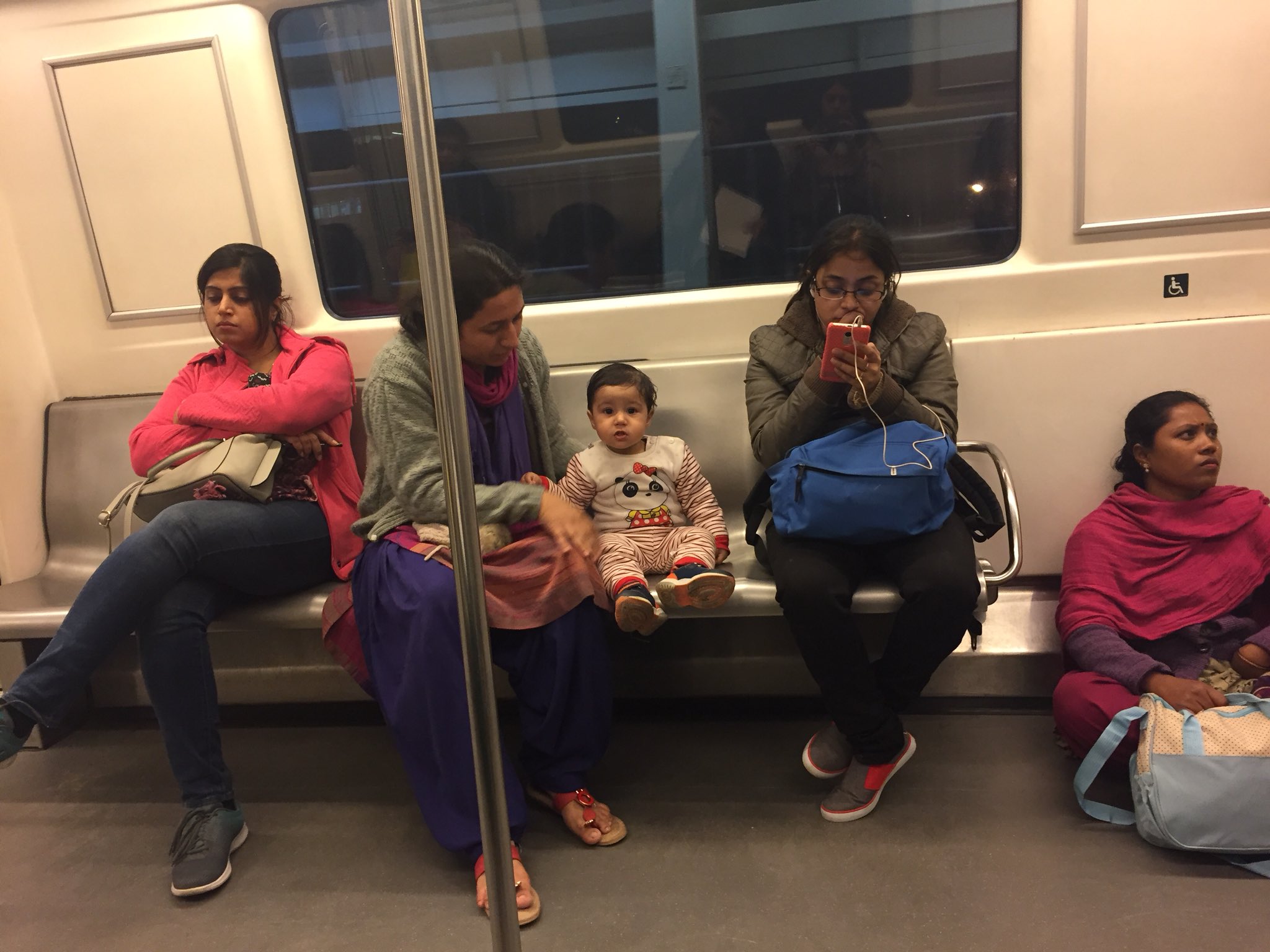Caretaker sitting on the floor in metro