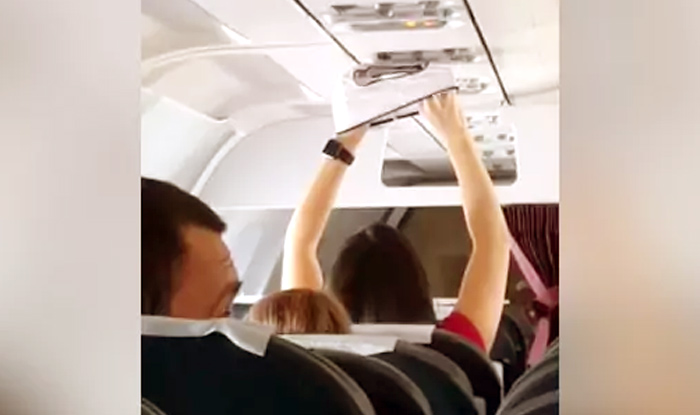 Woman dries her underwear under AC vent in flight